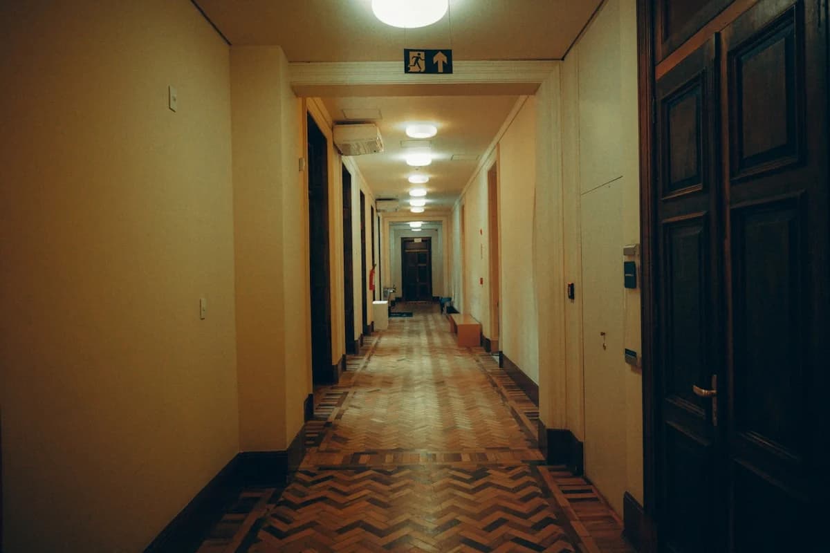 Long, dimly lit hallway with patterned floor