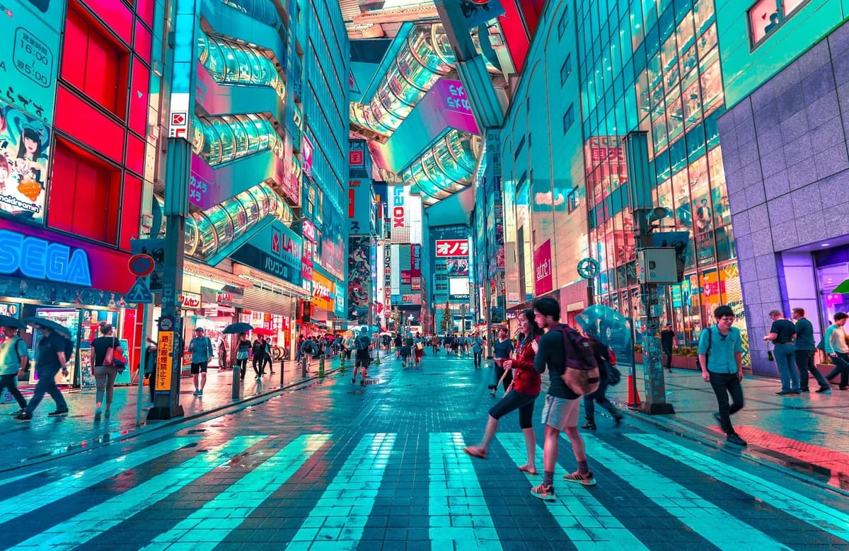 People walking on road near well-lit buildings in Tokyo